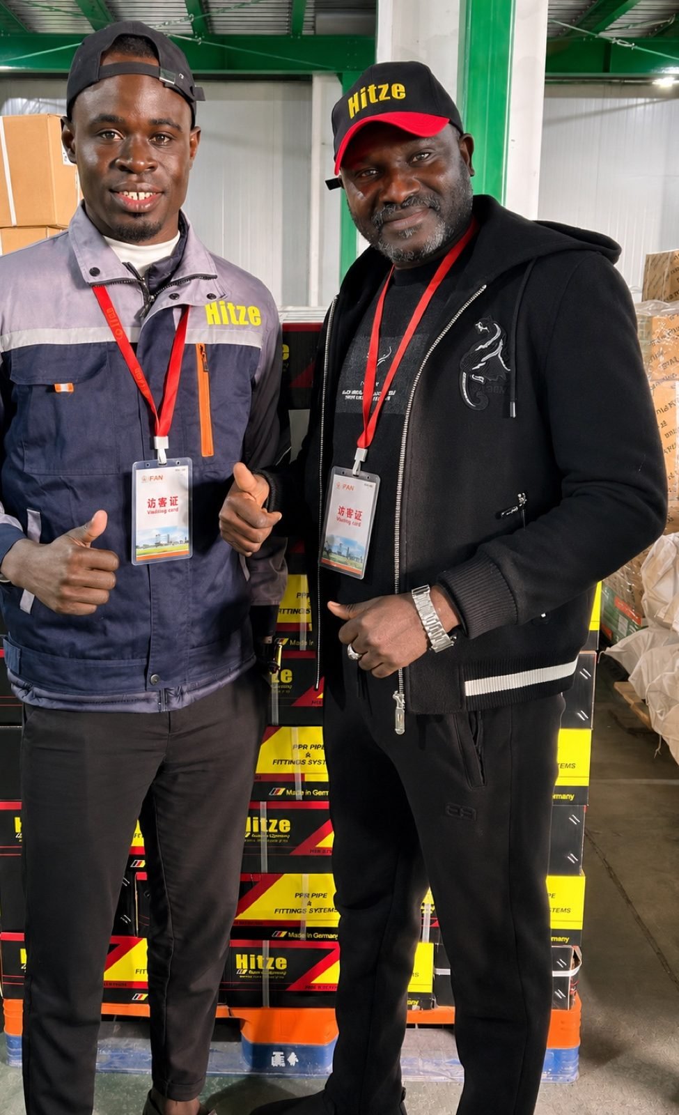Two importer partners in Hitze caps beside branded Hitze product boxes