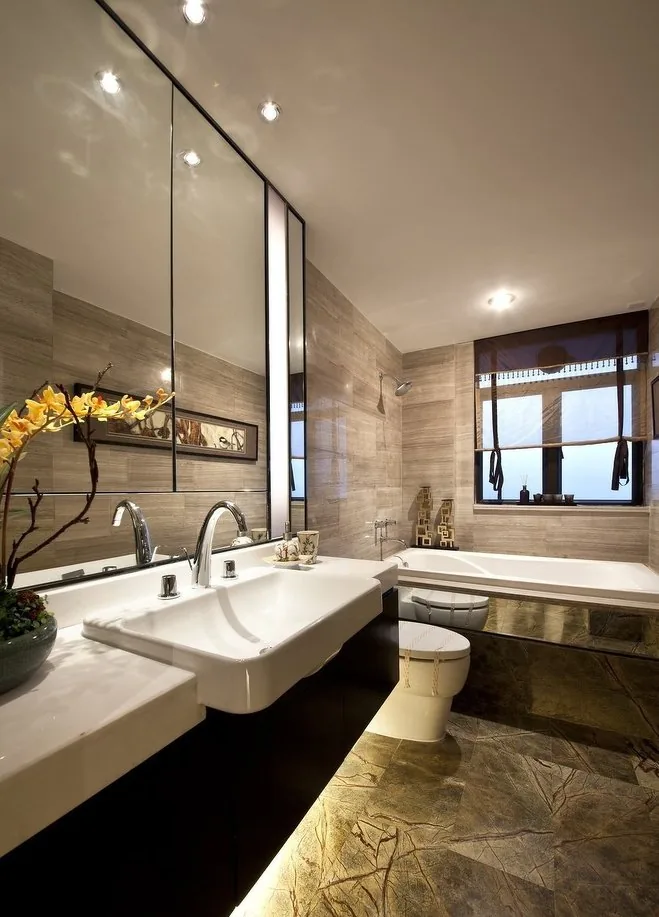 Bathroom vanity with twin chrome basin mixers, mirror and bathtub