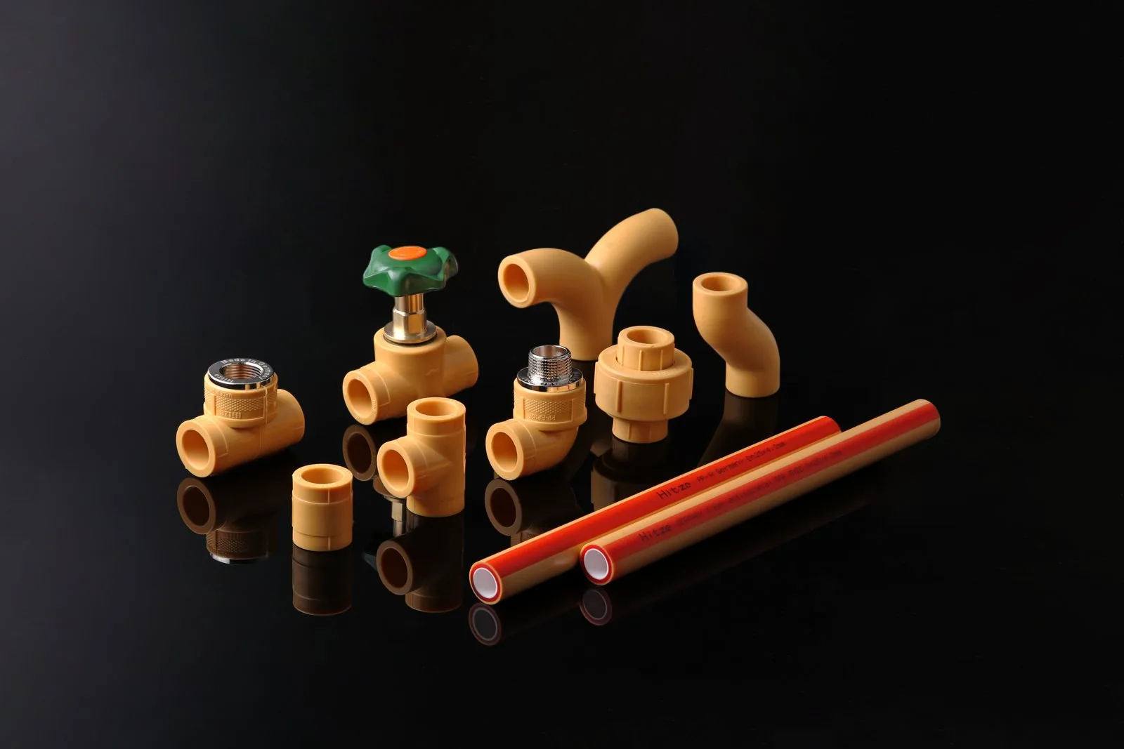 Hitze PP-R system on a dark surface — fittings, valve and low-expansion composite pipe