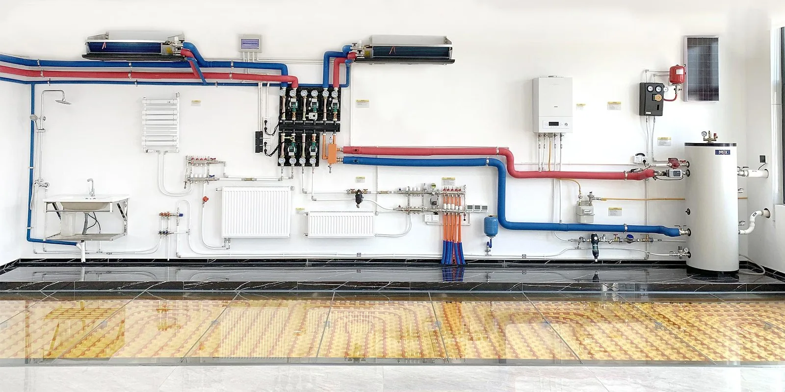 Whole-house hydronic plant room with boiler, cylinder and a manifold feeding radiant floor loops