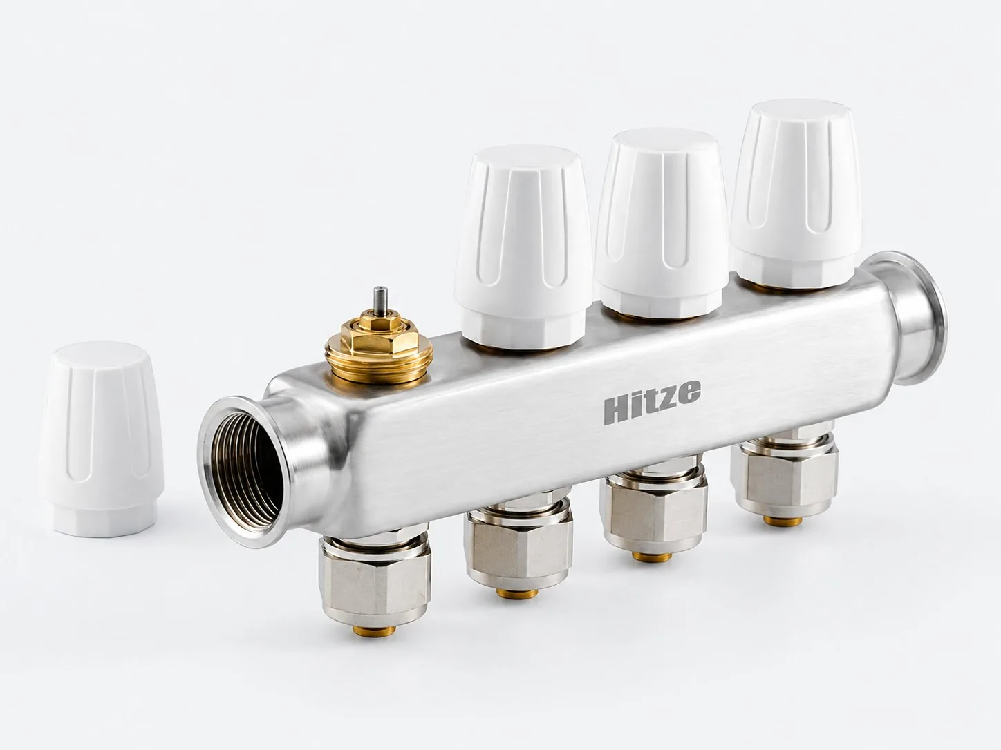 White thermostatic actuator head on a stainless manifold return port, one cap removed to show the M30 by 1.5 valve stem